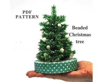 May include: A beaded Christmas tree with white beads and a teal polka dot base. The tree is on a hand and the text "PDF PATTERN" and "Beaded Christmas tree" is visible.