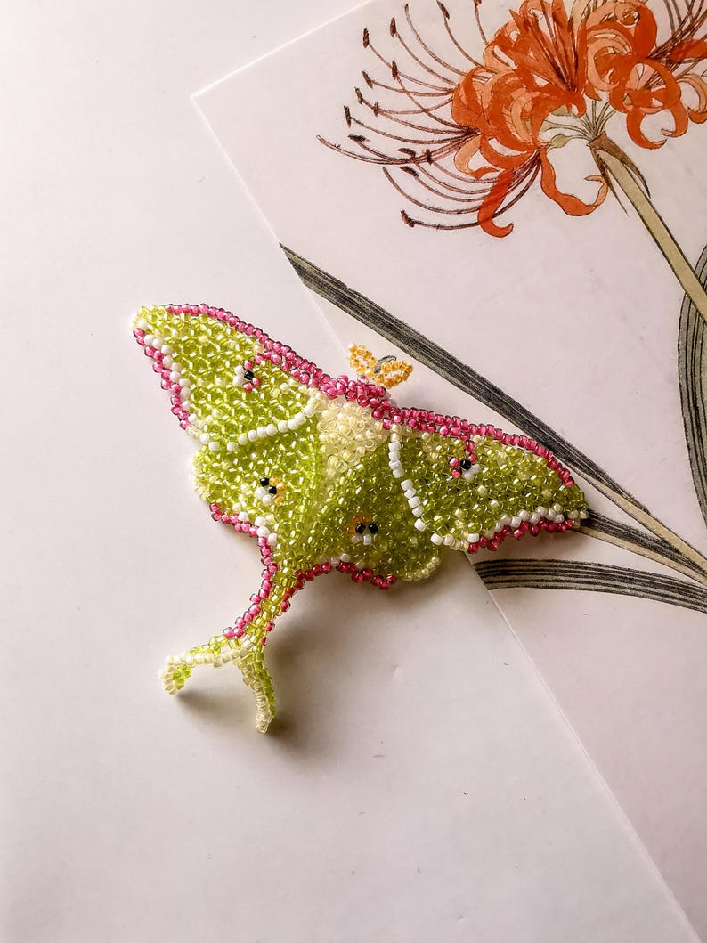 Luna moth seed bead brooch on floral paper — DIY beadweaving tutorial PDF