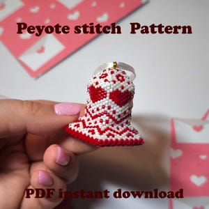 May include: A beaded bell-shaped ornament in red and white, featuring heart designs. The ornament is held by a hand. The text "Peyote stitch Pattern" and "PDF instant download" are visible.