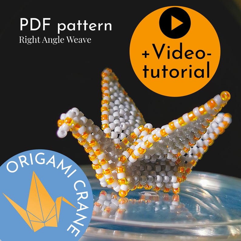 May include: A white origami crane made with beads, with orange beads outlining the folds. The crane is sitting on a clear plastic container with a black and white logo that says "Origami Crane". The text "PDF pattern Right Angle Weave" is at the top of the image.