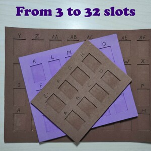 May include: Three brown cardboard pieces with cut-out slots labeled with letters. The top piece has nine slots labeled A through I. The middle piece has four slots labeled K through N. The bottom piece has 19 slots labeled A through AF. The text "From 3 to 32 slots" is written in purple at the top of the image.