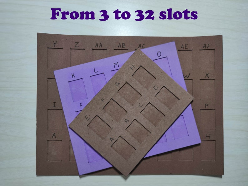 May include: Three brown cardboard pieces with cut-out slots labeled with letters. The top piece has nine slots labeled A through I. The middle piece has four slots labeled K through N. The bottom piece has 19 slots labeled A through AF. The text "From 3 to 32 slots" is written in purple at the top of the image.