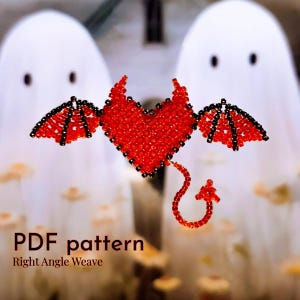 Op de afbeelding: Een rood kralenhart met zwarte kralenvleugels en een staart, gevormd als een duivel. Het hart is scherp, de achtergrond is wazig. De tekst "PDF pattern Right Angle Weave" staat onderaan de afbeelding.