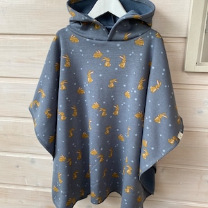 Car seat/stroller poncho with hood. Essential for the safety of your baby and toddler. Cozy alpine fleece with bunny motif.