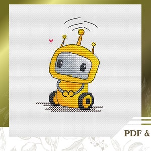 May include: A yellow robot with a black antenna and wheels, sitting on a white background. The robot has a heart shape on its chest and a small pink heart above it.