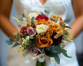 May include: A bridal bouquet with a mix of orange, red, white, and cream flowers. The bouquet is made up of roses, carnations, and other flowers.