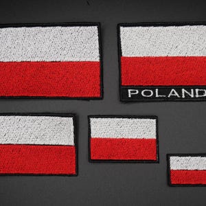 May include: A collection of embroidered Polish flag patches in different sizes. Each patch displays the Polish flag design: a white top and a red bottom, with a black border. One patch has the word "POLAND".