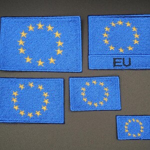 May include: A set of blue embroidered patches depicting the European Union flag. Each patch shows a blue field with a circle of yellow stars. One patch is labelled "EU".