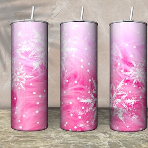 May include: Three stainless steel tumblers with pink and white ombre designs featuring snowflakes.