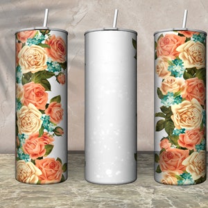 May include: A white, stainless steel tumbler with a floral design. The design features peach and cream-colored roses, small blue flowers, and green leaves. The tumbler has a silver lid and a white straw.
