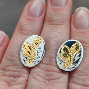 Vintage. A pair of silver cufflinks with gold decoration.