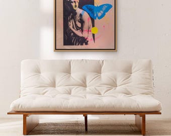 May include: A framed wall art print featuring a classical statue bust in black and white, accented with a vibrant blue butterfly, a bright pink circle, and a yellow circle against a soft pink background, all enclosed in a thin wooden frame.
