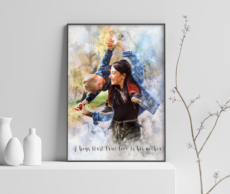 May include: A watercolor painting of a mother and child. The mother is holding the child up in the air, and they are both smiling. The text "A boy's first true love is his mother" is written at the bottom of the painting.