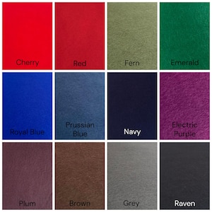May include: A grid of twelve felt fabric swatches in various colors labeled Cherry, Red, Fern, Emerald, Royal Blue, Prussian Blue, Navy, Electric Purple, Plum, Brown, Grey, and Raven. Each square displays a distinct solid color and texture.