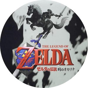 May include: Circular graphic featuring the title "THE LEGEND OF ZELDA" in red and gold, with a blue shield and sword. A silhouetted rider on horseback is above the title, set against a black and white background.