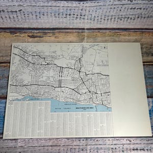 May include: A printed map of Southend-on-Sea featuring black street lines on a cream background, with a blue section labeled River Thames. The map includes a road index at the bottom and grid coordinates along the top and sides for navigation.