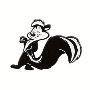May include: A black and white enamel pin featuring a cartoon skunk character with a confident expression. The skunk has a white stripe down its chest and a large, curved tail. The pin is set against a white background.