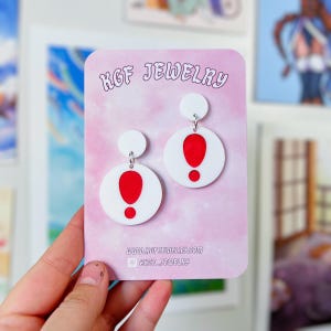 May include: White and red exclamation point earrings on a pink background with the text "KGF JEWELRY" and the website address "www.kgfjewelry.com".
