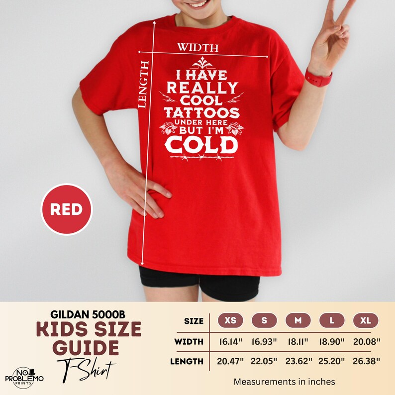 May include: A red short-sleeved t-shirt featuring white text that reads I HAVE REALLY COOL TATTOOS UNDER HERE BUT I'M COLD. The image includes a size guide with width and length measurements in inches for sizes XS through XL, ranging from 16.14 to 26.38 inches.