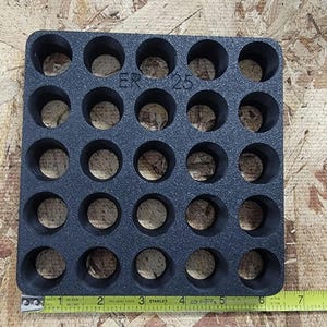 May include: Black foam insert with 25 circular cutouts, labeled "ER 25".