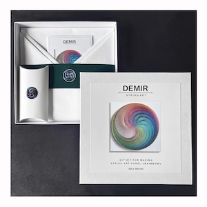 May include: A white square box containing a DIY string art kit labeled DEMIR STRING ART. The kit includes a rainbow-colored circular string art design, a small white pillow box, and a card, all measuring 300 x 300 mm as printed on the box.