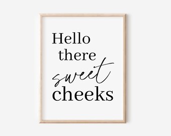 May include: A black and white printable wall art print with the text "Hello there sweet cheeks".