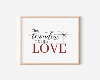 May include: A framed print with the text "The Wonders of His LOVE" in black and red lettering. A starburst design is above the word "Wonders".