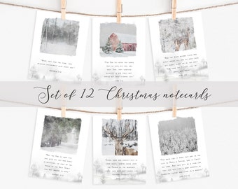 May include: A set of 12 Christmas notecards hanging from a twine string with wooden clothespins. Each card features a winter landscape scene with a Bible verse. The cards have a watercolor style with a snowy forest, a deer, and a red barn.