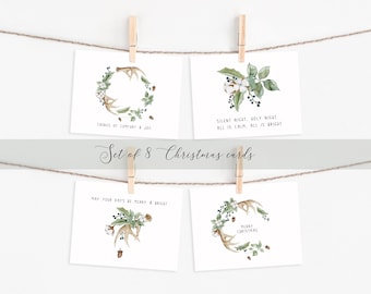 May include: Set of eight Christmas cards featuring watercolor illustrations of wreaths with antlers, berries, and cotton bolls. The cards have various Christmas greetings, including "Tidings of Comfort & Joy", "Silent Night, Holy Night, All is Calm, All is Bright", "May Your Days Be Merry & Bright", and "Merry Christmas".