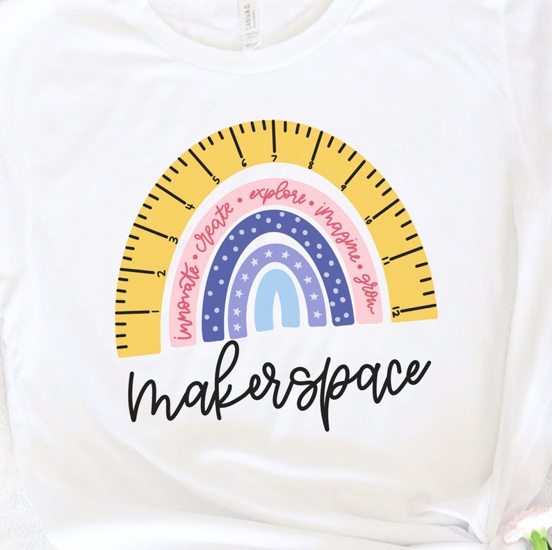 May include: White t-shirt with a rainbow design incorporating a ruler arc. The rainbow includes the words "innovate, create, explore, imagine, grow." The word "makerspace" is written in a script font below the rainbow.