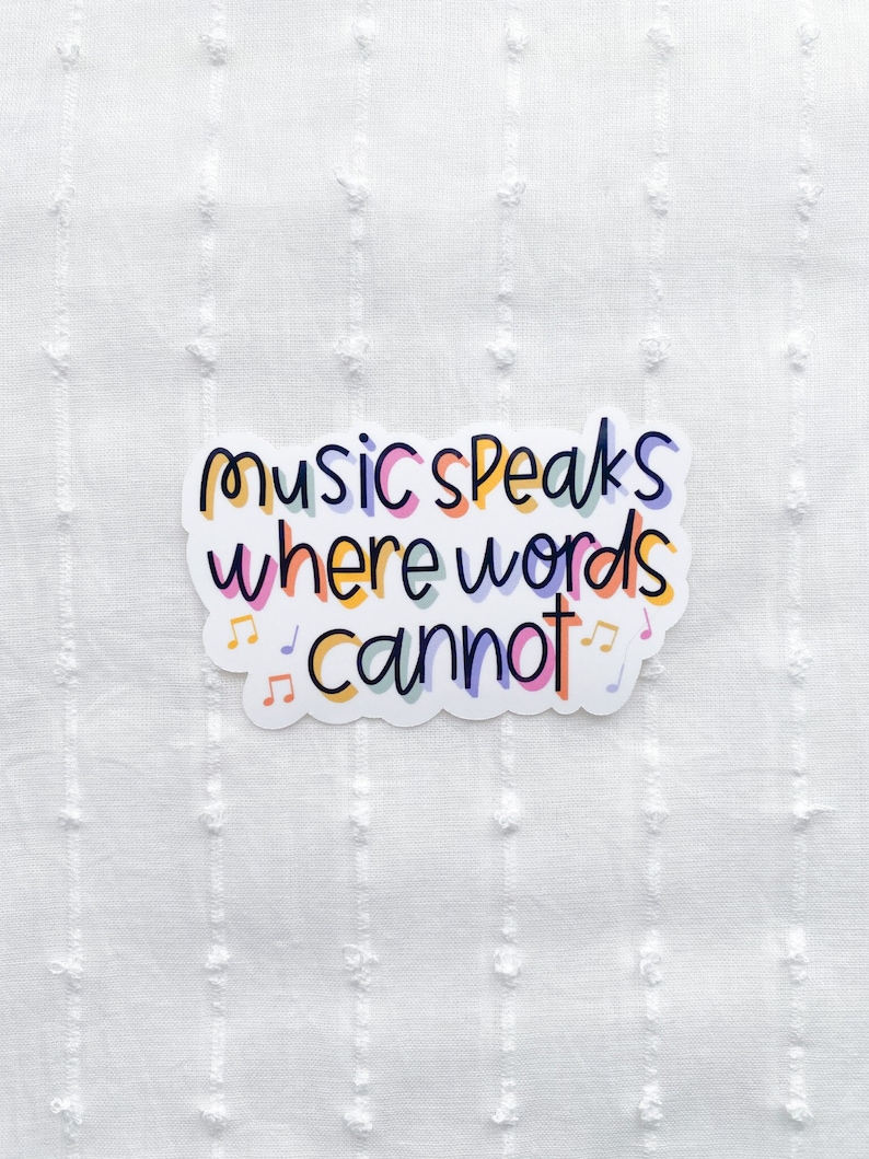 May include: A white sticker with the text "music speaks where words cannot" in colorful letters. Musical notes are around the text.