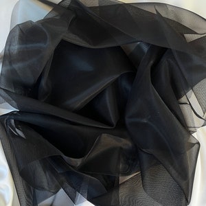 May include: Black sheer tulle fabric, a lightweight and delicate material with a fine mesh texture.