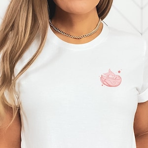 May include: White t-shirt with a pink graphic of a sleeping fox with stars on a white background.