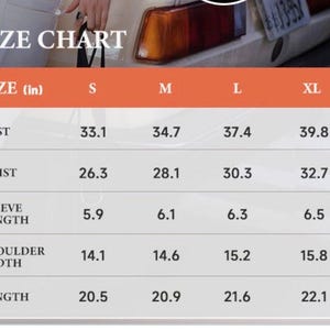 May include: A size chart with measurements in inches for bust, waist, sleeve length, shoulder width, and length. The chart includes sizes S, M, L, and XL, with corresponding measurements for each size. The text "SIZE CHART" is at the top.
