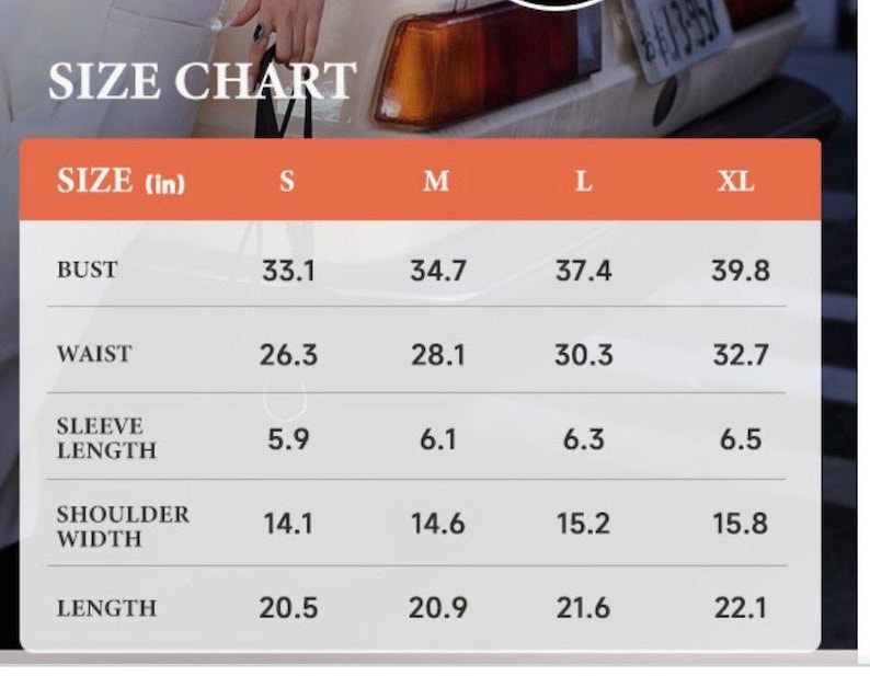 May include: A size chart with measurements in inches for bust, waist, sleeve length, shoulder width, and length. The chart includes sizes S, M, L, and XL, with corresponding measurements for each size. The text "SIZE CHART" is at the top.