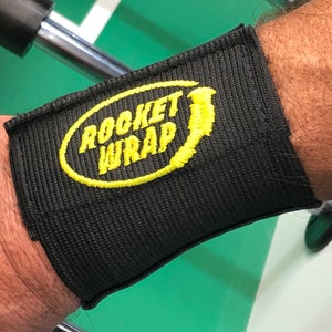 May include: Black wrist wrap with yellow stitching and the text "ROCKET WRAP" in a yellow oval.