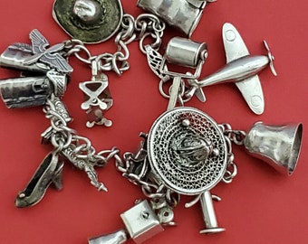 16 charm Bracelet with vintage 1960 & 1970 sterling silver charms 26.5grams