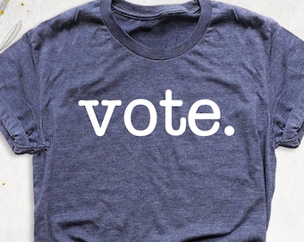May include: A dark blue t-shirt with the word "vote" printed in white on the front.