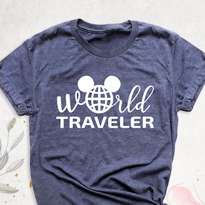 May include: A dark blue t-shirt with a white graphic of Mickey Mouse ears with a globe inside the ears and the text "World Traveler" underneath.