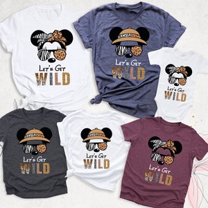 May include: Five t-shirts with a cartoon image of Mickey Mouse wearing a safari hat and sunglasses. The shirts have the text "Let's Get Wild" with a zebra and leopard print design.