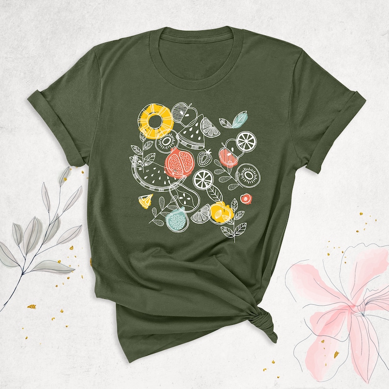 May include: A green t-shirt with a white graphic of various fruits and vegetables, including watermelon, pineapple, kiwi, and strawberries.