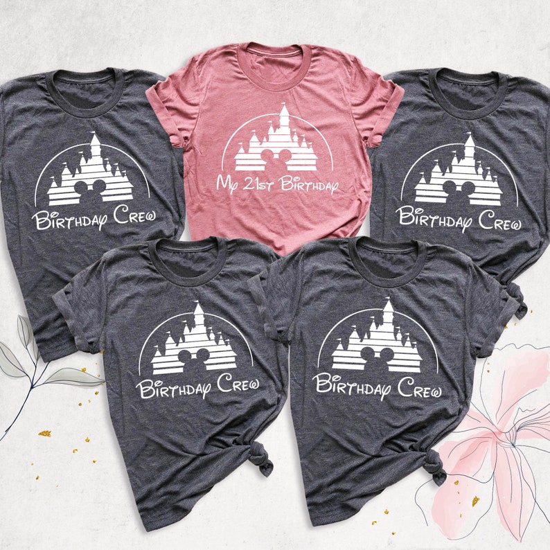 May include: Four gray t-shirts with a white silhouette of Cinderella's castle and Mickey Mouse ears. One pink t-shirt with the same design and the text "My 21st Birthday".