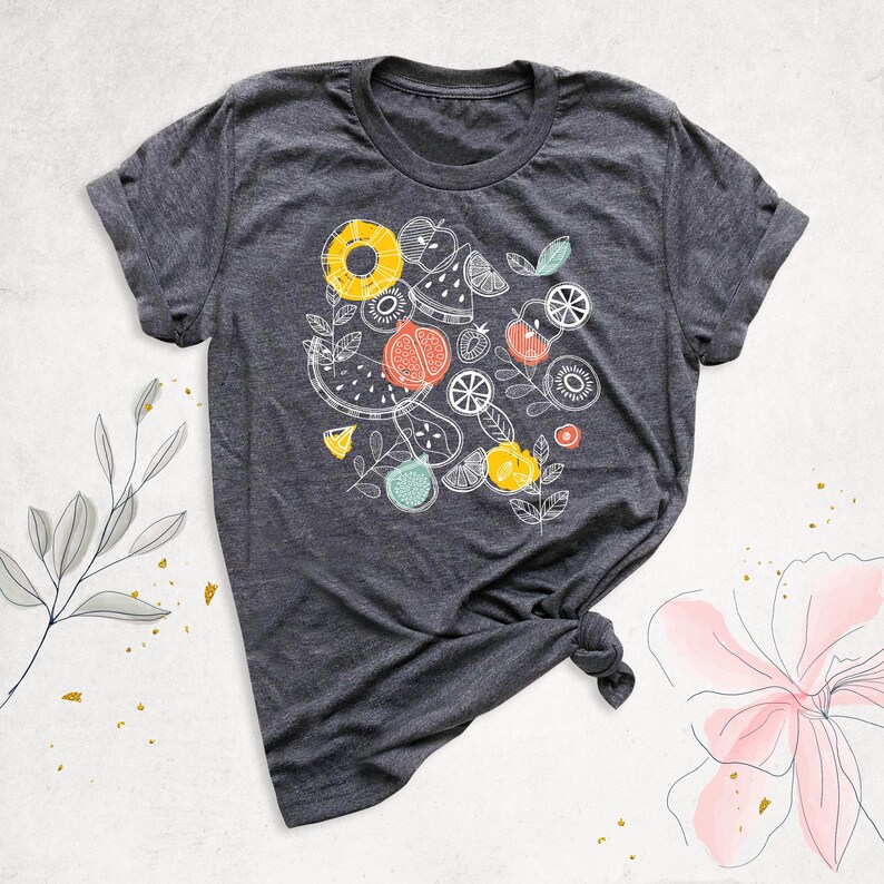 May include: A dark gray t-shirt with a white graphic design of various fruits, including watermelon, pineapple, kiwi, and oranges.