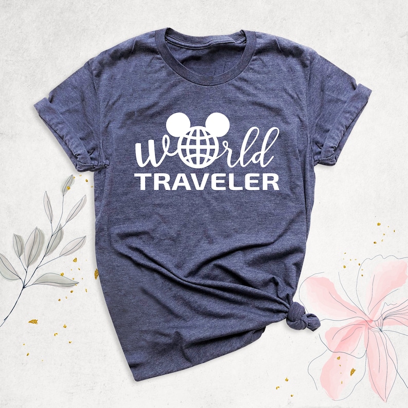 May include: A dark blue t-shirt with a white graphic of Mickey Mouse ears with a globe inside the ears and the text "World Traveler" underneath.