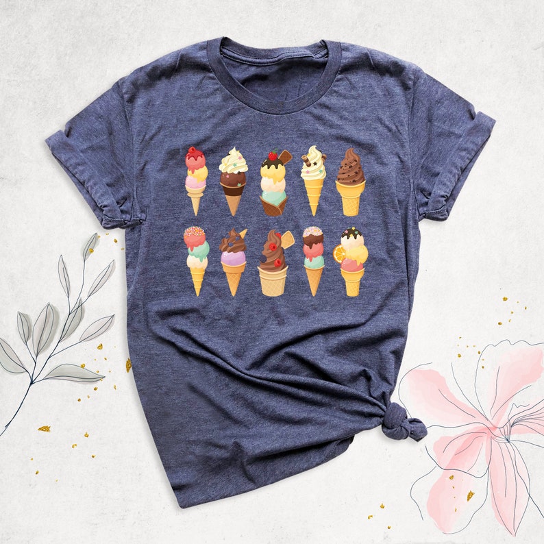 May include: A dark blue t-shirt with a design of various ice cream cones in different colors and flavors. The ice cream cones are arranged in two rows of five.