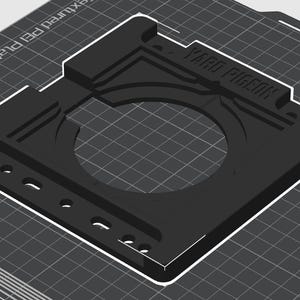 May include: Black plastic 3D printed camera mount with the text "YARD PIG" printed on the top. The mount has a circular opening in the center and several small holes around the edges.