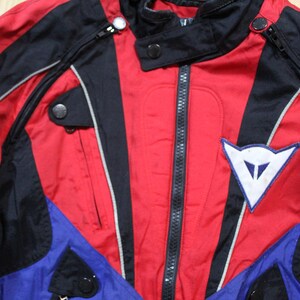 May include: A white ceramic mug with a black handle and the text "But First, Coffee" in a black, handwritten-style font. The mug is on a white surface.