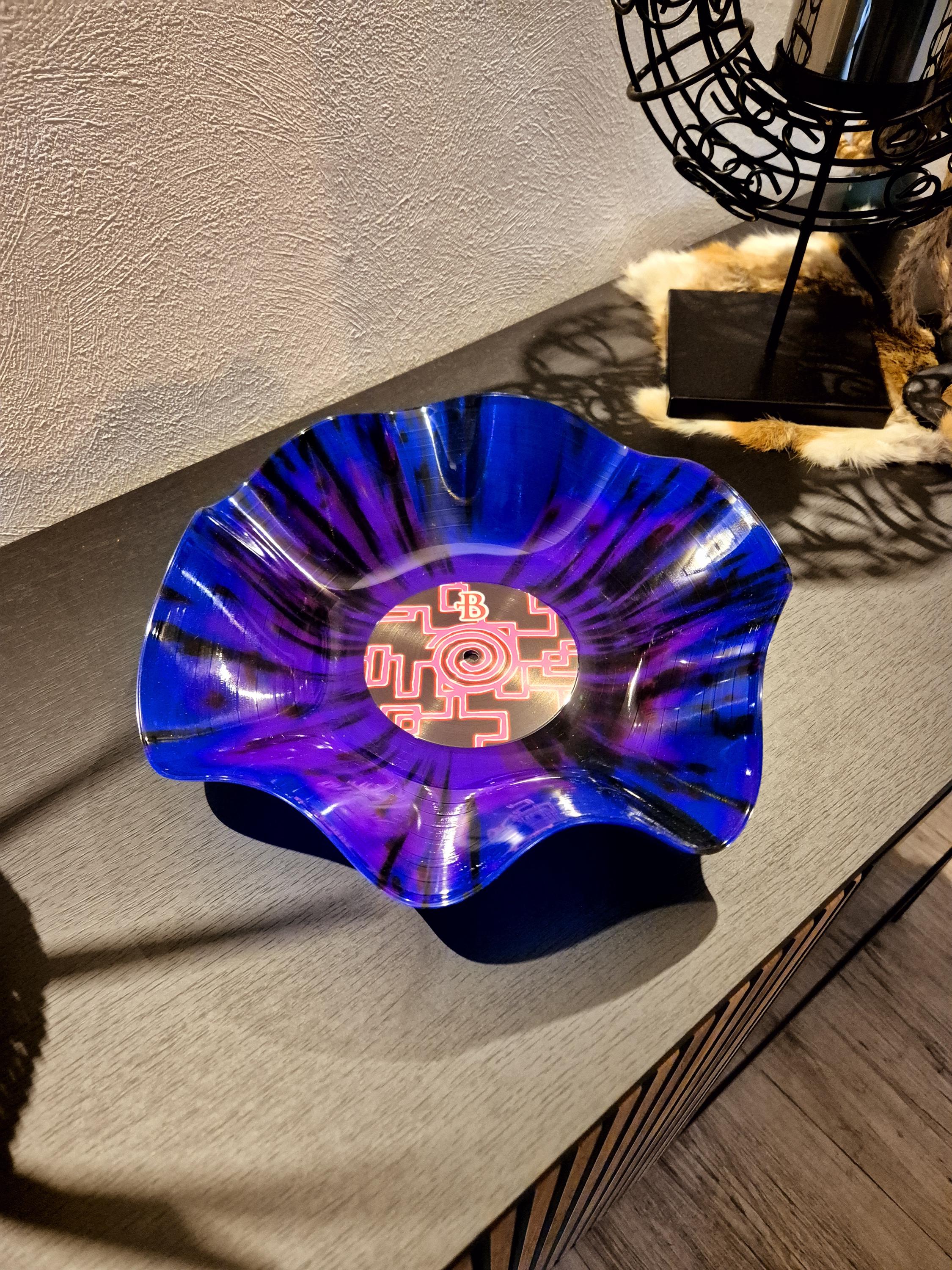 Colorful record bowl made from a real vinyl record that has been turned into an extraordinary decoration/art object.