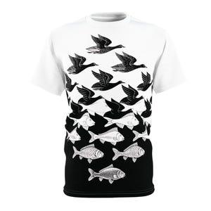 May include: A white t-shirt with a black and white optical illusion design. The design features a flock of birds that can also be seen as a school of fish.
