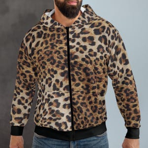 May include: A brown and black leopard print zip-up hoodie with a black zipper and black trim around the hood and cuffs.